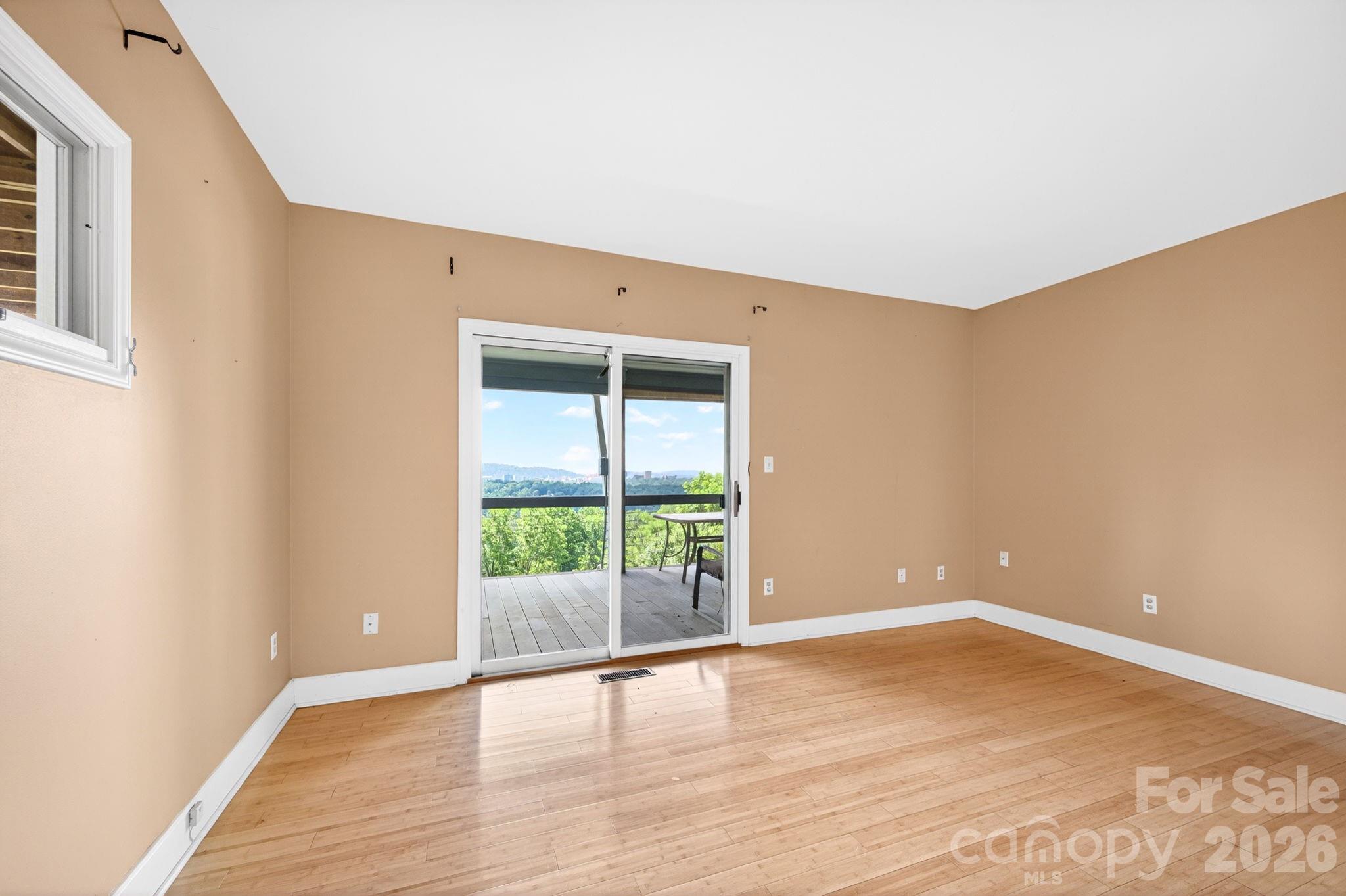 38 Lookout Road Asheville, NC 28804 - Photo 27 of 34 an empty room with wooden floor and windows
