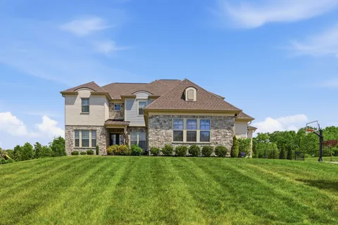a front view of a house with a yard