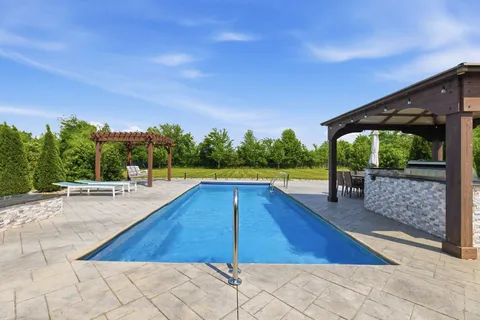 a swimming pool with wooden fence