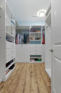 a bathroom with a granite countertop toilet sink mirror and vanity