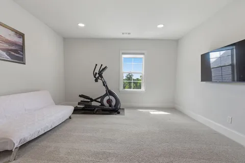 a bedroom with a bed and a refrigerator