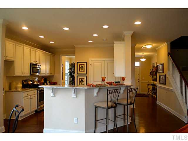 804 Chapanoke Road Raleigh, NC 27603 - Photo 11 of 25 Dream Kitchen offers: stainless steel appliances, gas range, 42" cabinets, tiled back splash, granite counter tops, recessed lights, pull out faucet! Kitchen