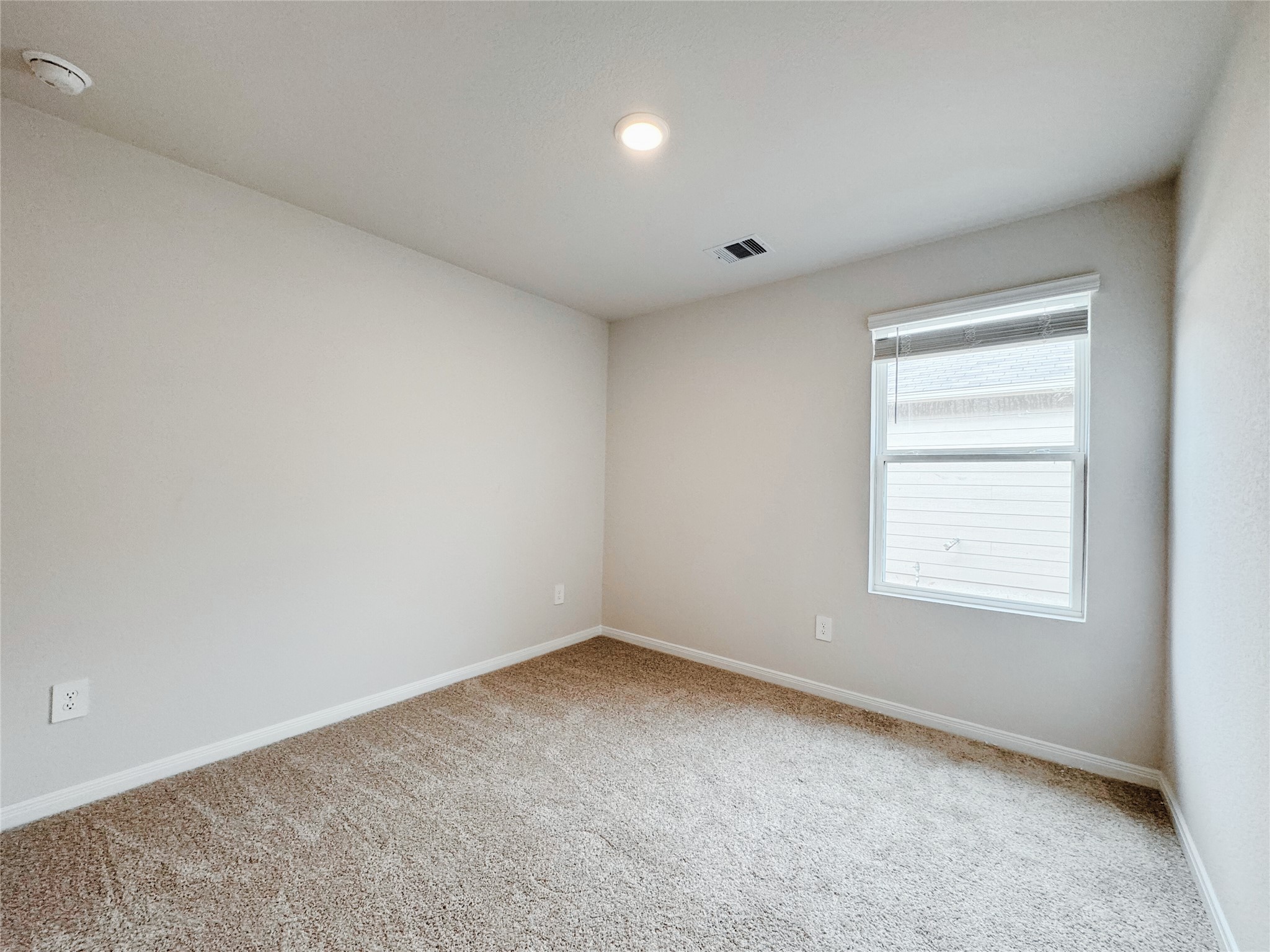 204 Addison Place Lockhart, TX 78644 - Photo 17 of 39 Empty room featuring baseboards and light carpet