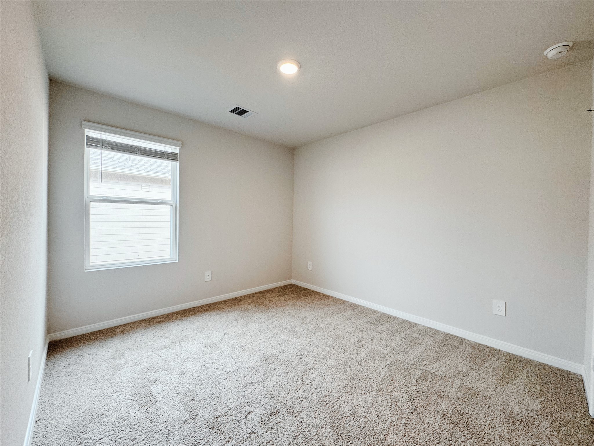 204 Addison Place Lockhart, TX 78644 - Photo 18 of 39 Empty room with light colored carpet and baseboards