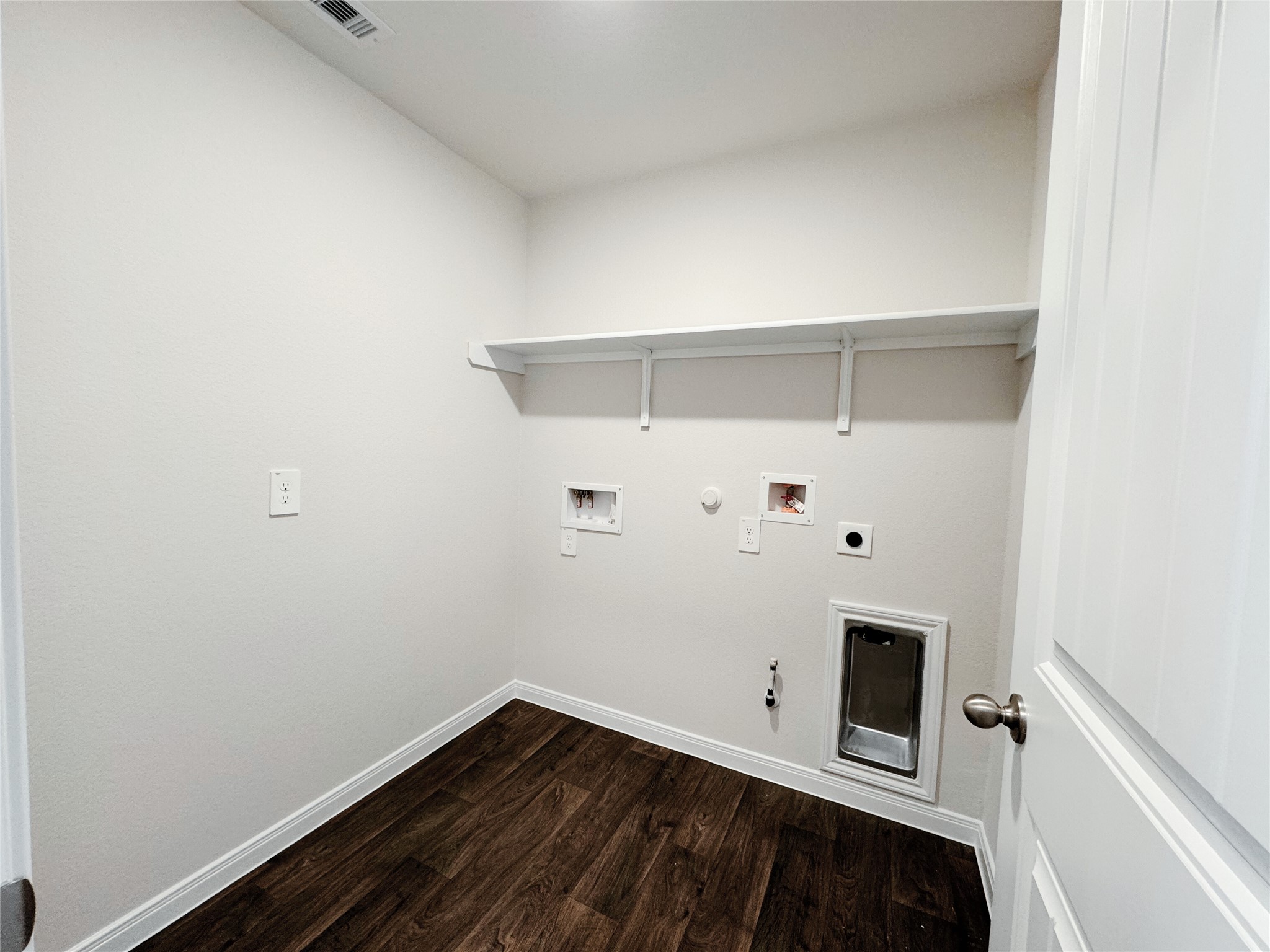204 Addison Place Lockhart, TX 78644 - Photo 19 of 39 Laundry room featuring gas dryer hookup, dark wood-type flooring, hookup for a washing machine, and electric dryer hookup