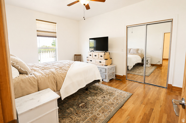 1055 North 1000 East Mapleton, UT 84664 - Photo 42 of 112 Spacious room featuring wood-finish flooring, a window with a roman shade, and mirrored closet doors