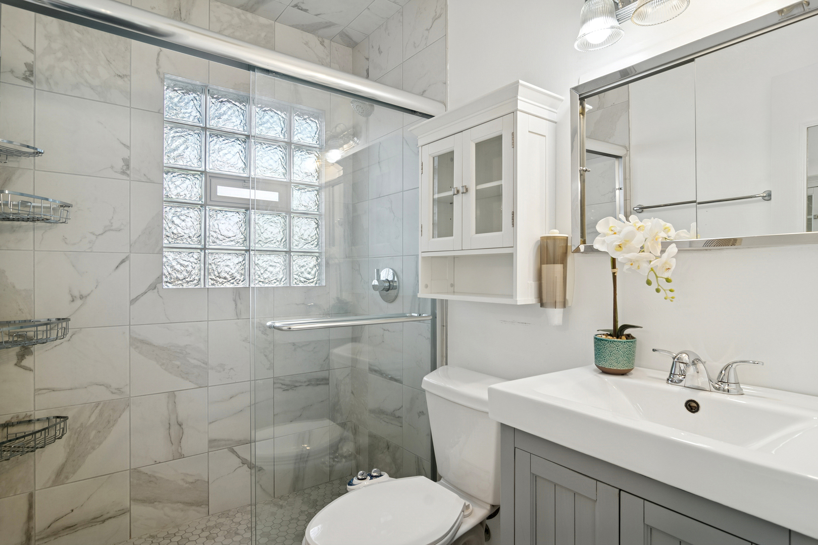 36 Crestview Terrace Buffalo Grove, IL 60089 - Photo 22 of 30 a bathroom with a sink toilet a mirror and shower