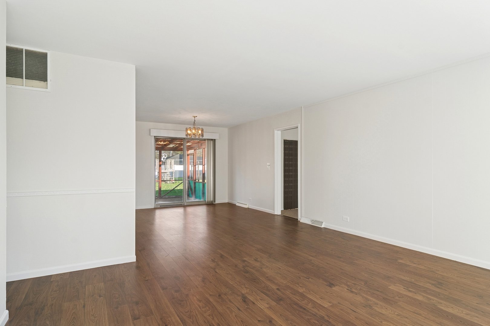 36 Crestview Terrace Buffalo Grove, IL 60089 - Photo 4 of 30 a view of an empty room with wooden floor and a window