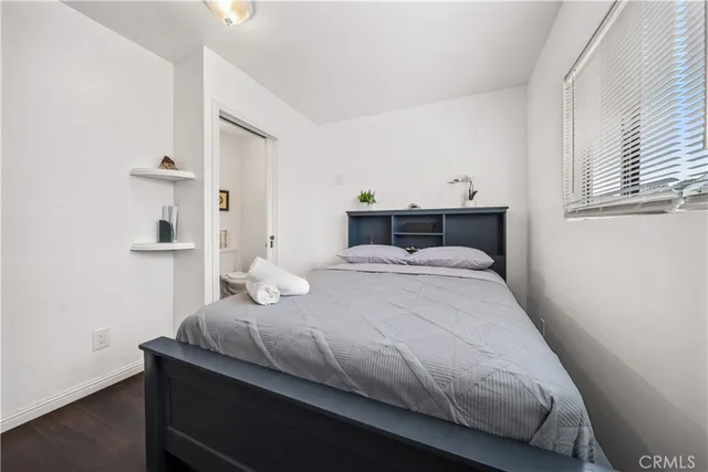 a bedroom with a bed and window