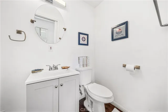 a bathroom with a sink mirror and toilet
