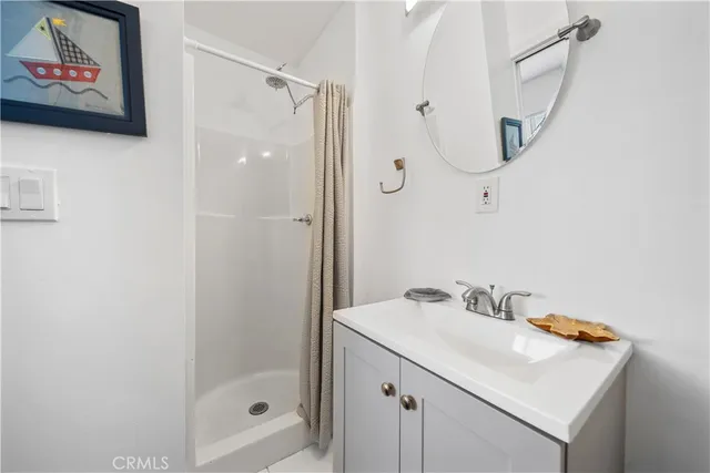 a bathroom with a granite countertop sink a mirror a shower and a bathtub