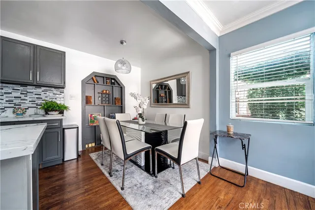 a dining room with furniture and wooden floor