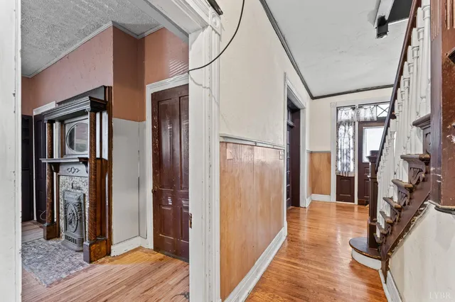a view of hallway with wooden floor and stairs