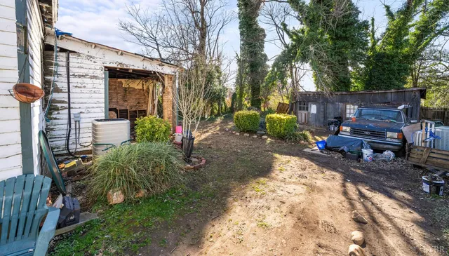 a group of people sitting in front of a house