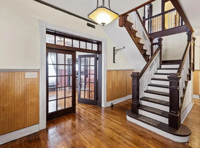 a view of entryway with wooden floor and front door