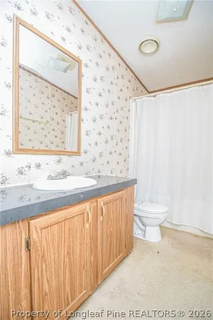 a kitchen with granite countertop a stove a sink and a refrigerator