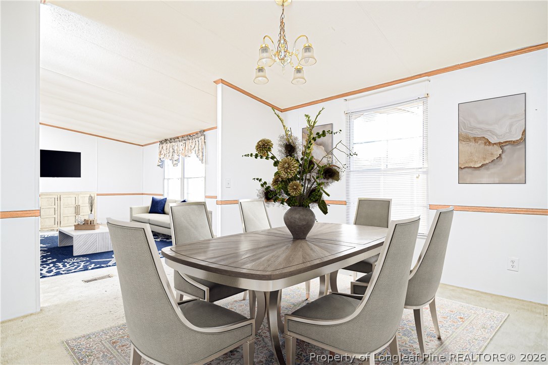 6331 Sandy Creek Road Stedman, NC 28391 - Photo 14 of 29 a view of a dining room with furniture and wooden floor