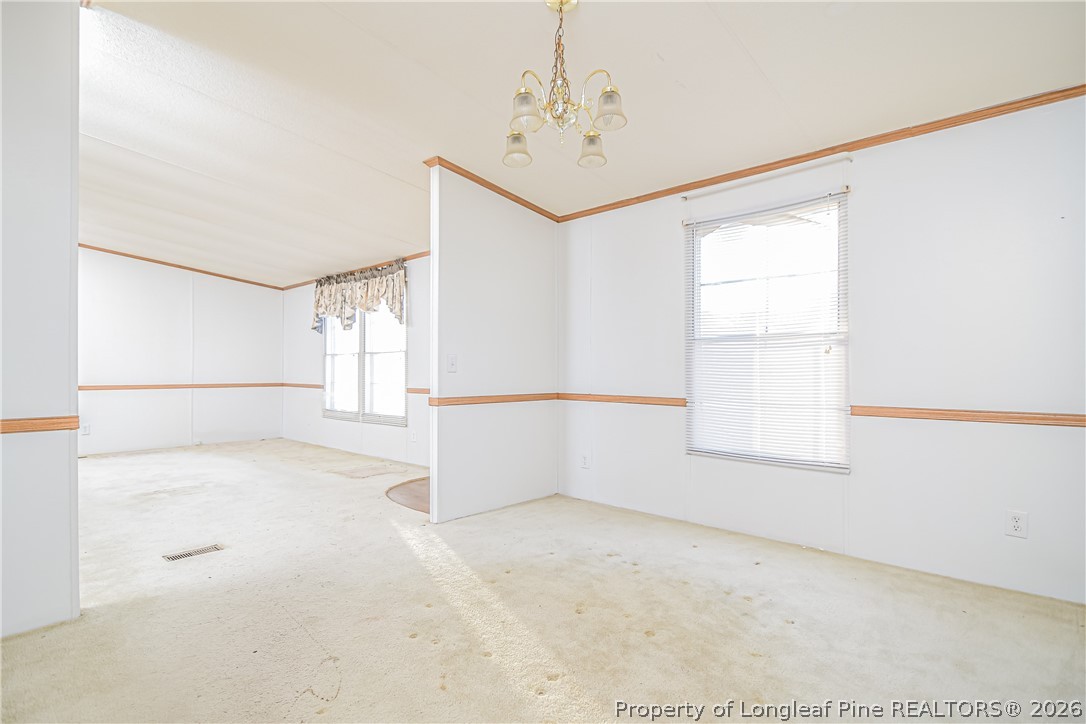 6331 Sandy Creek Road Stedman, NC 28391 - Photo 15 of 29 an empty room with windows and refrigerator