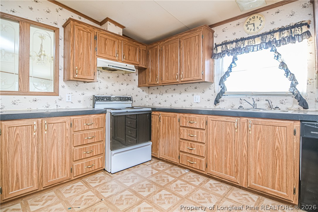 6331 Sandy Creek Road Stedman, NC 28391 - Photo 17 of 29 a kitchen with granite countertop a sink stainless steel appliances and cabinets
