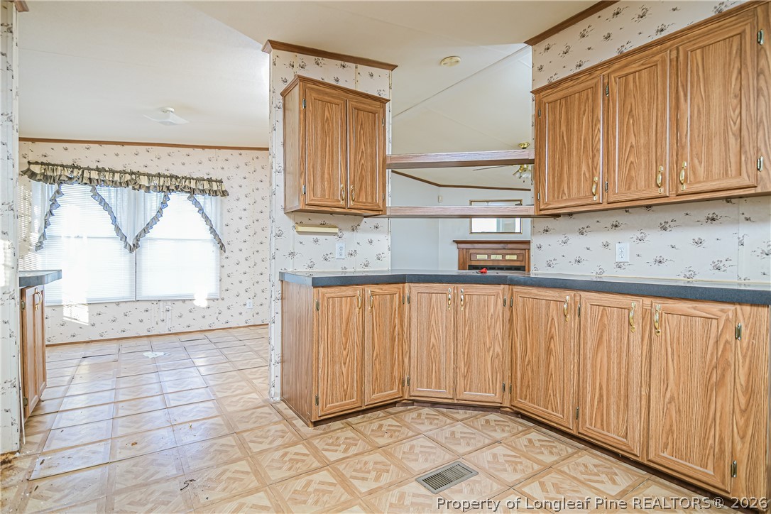 6331 Sandy Creek Road Stedman, NC 28391 - Photo 18 of 29 a view of kitchen with granite countertop white cabinets and sink