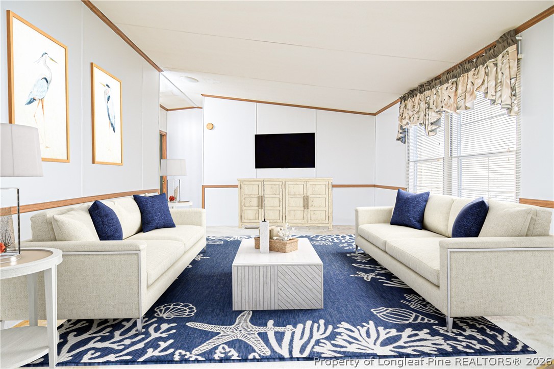 6331 Sandy Creek Road Stedman, NC 28391 - Photo 2 of 29 a living room with furniture and a flat screen tv