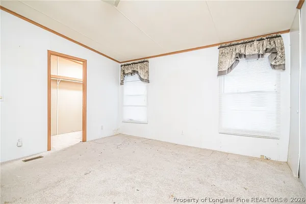 a view of a room with wooden floor and cabinet