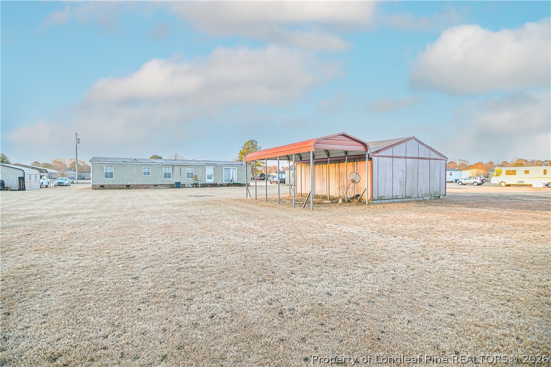6331 Sandy Creek Road Stedman, NC 28391 - Photo 29 of 29 a view of a house with a yard and wooden fence
