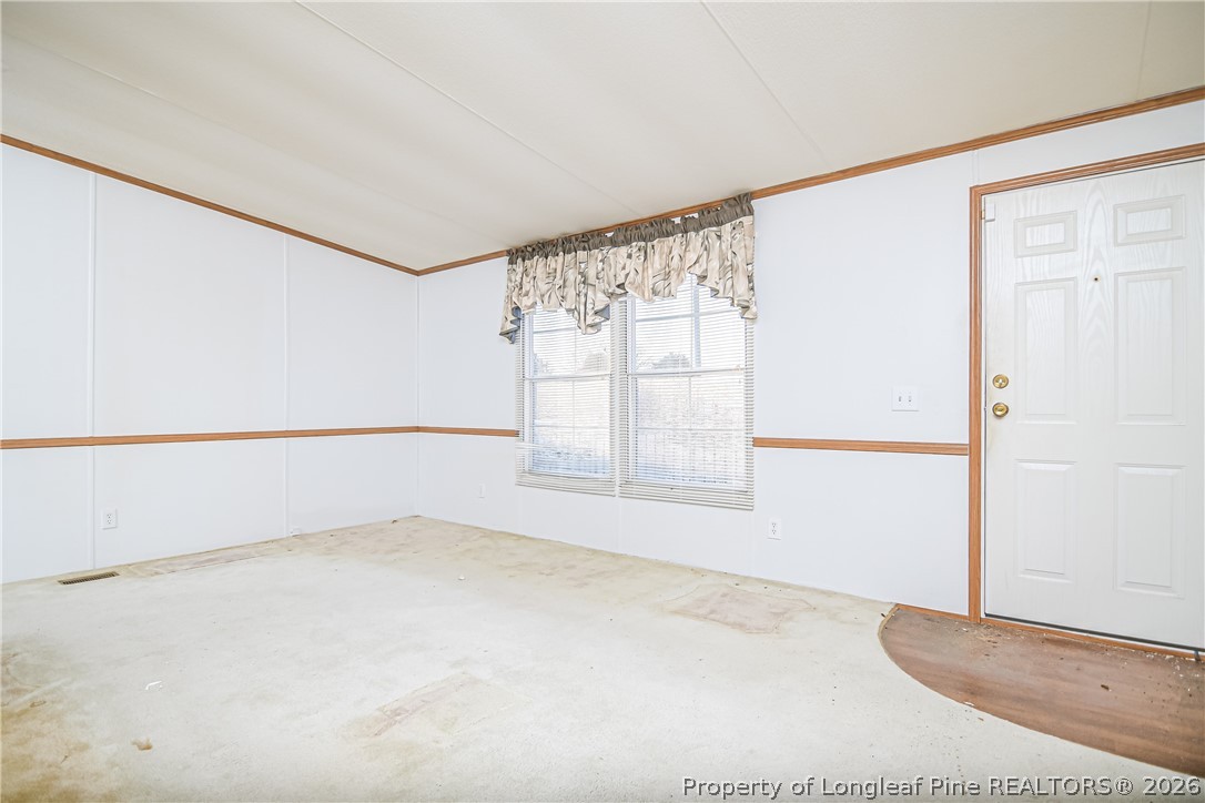 6331 Sandy Creek Road Stedman, NC 28391 - Photo 4 of 29 an empty room with windows