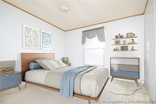 a bedroom with a bed and a painting on the wall