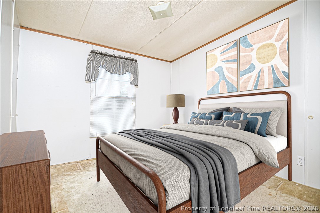 6331 Sandy Creek Road Stedman, NC 28391 - Photo 9 of 29 a bedroom with a bed and a painting on the wall