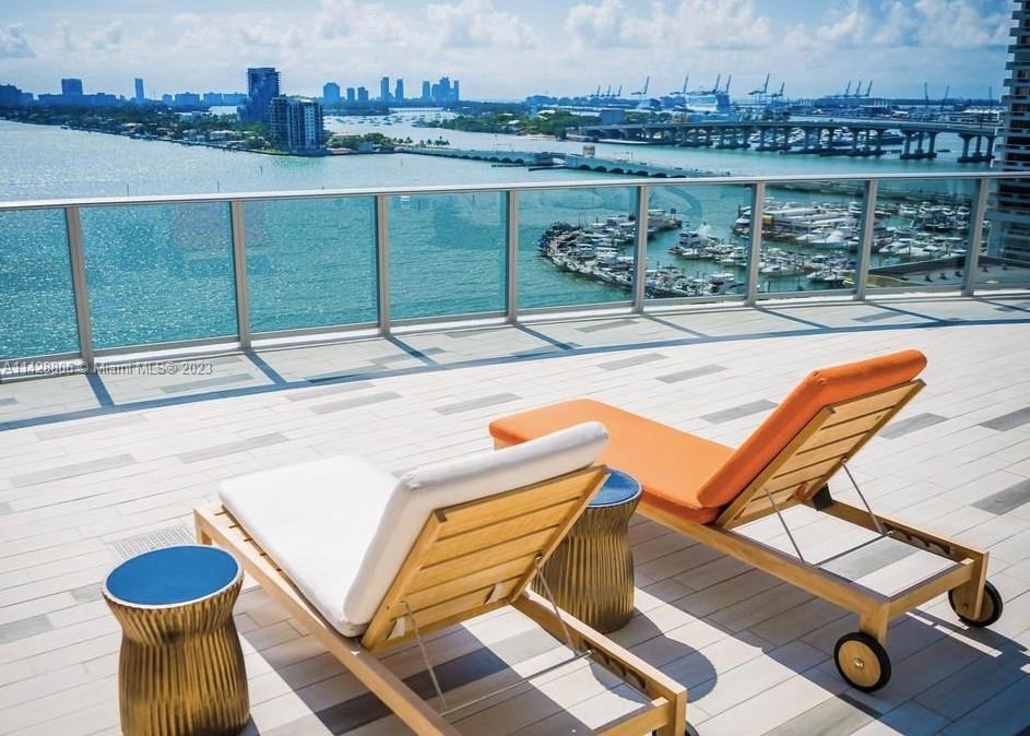 488 Northeast 18th Street, Unit 505 Miami, FL 33132 - Photo 19 of 35 a view of a swimming pool with lounge chairs