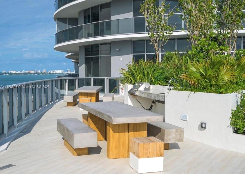 488 Northeast 18th Street, Unit 505 Miami, FL 33132 - Photo 25 of 35 a view of a patio with couches table and chairs and potted plants