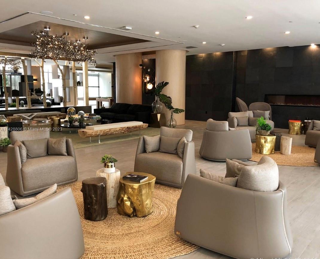 488 Northeast 18th Street, Unit 505 Miami, FL 33132 - Photo 32 of 35 a living room with furniture and a chandelier