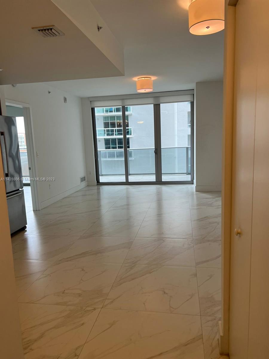 488 Northeast 18th Street, Unit 505 Miami, FL 33132 - Photo 4 of 35 a view of an empty room with a window