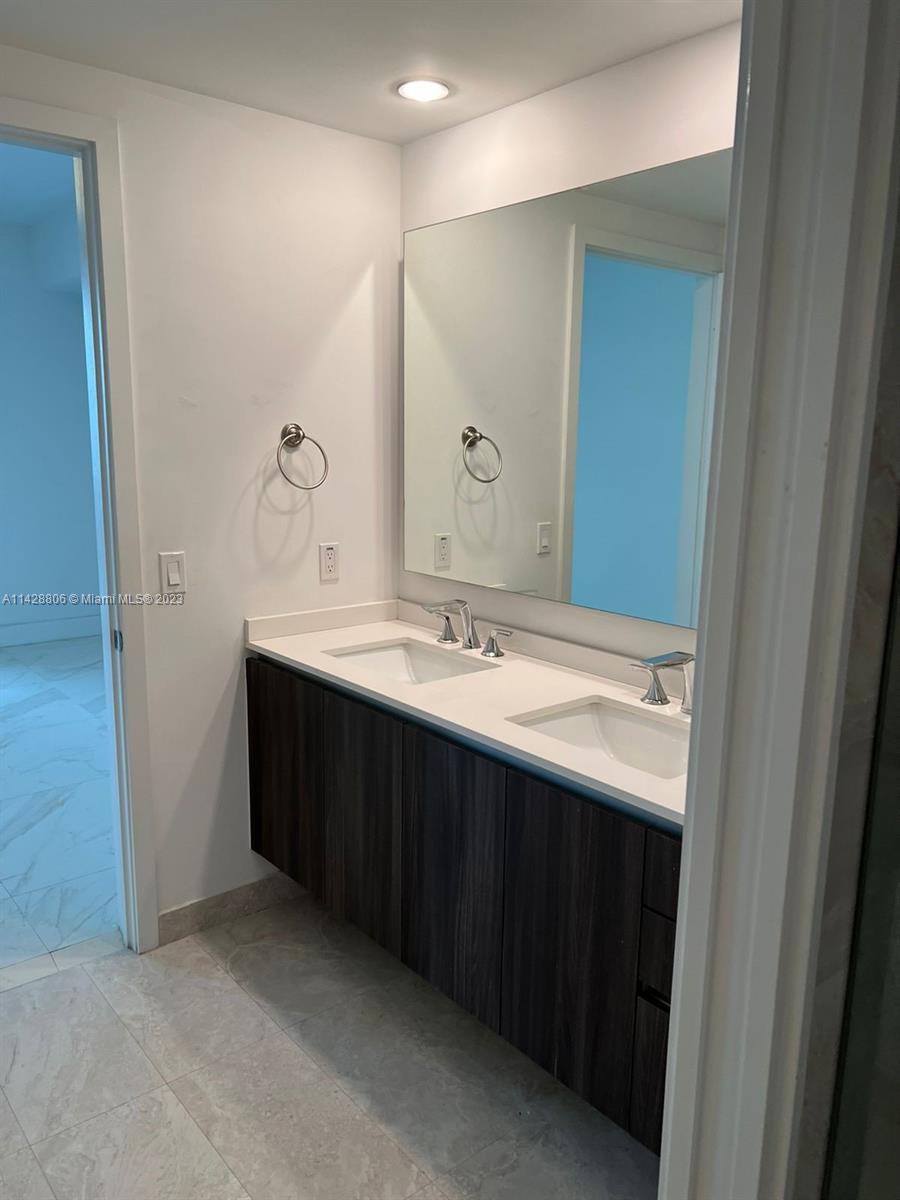 488 Northeast 18th Street, Unit 505 Miami, FL 33132 - Photo 10 of 35 a bathroom with a double vanity sink and a mirror