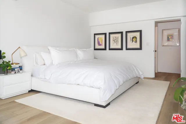 a large white bed in a white room