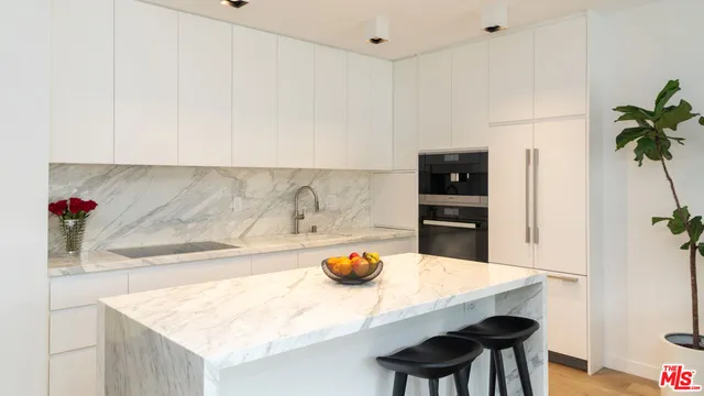 a kitchen with stainless steel appliances a sink and a refrigerator