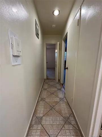 front view of a brick house with a yard