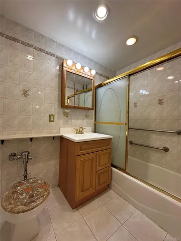 a bathroom with a tub sink and mirror