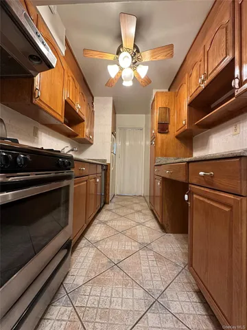 a kitchen with stainless steel appliances granite countertop a stove and a microwave