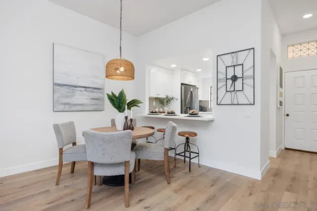 a kitchen with furniture and a potted plant