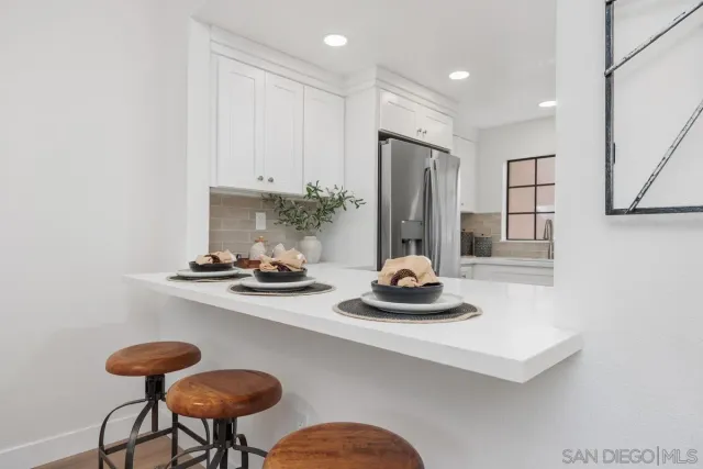 a kitchen with a refrigerator and a sink