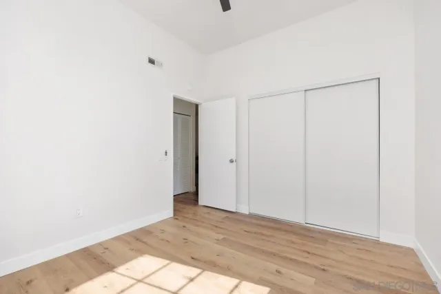 a bathroom with a granite countertop sink a toilet and a bathtub
