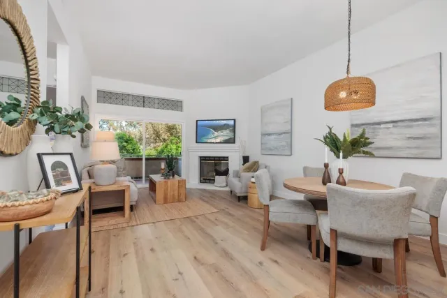 a living room with furniture a fireplace and a table