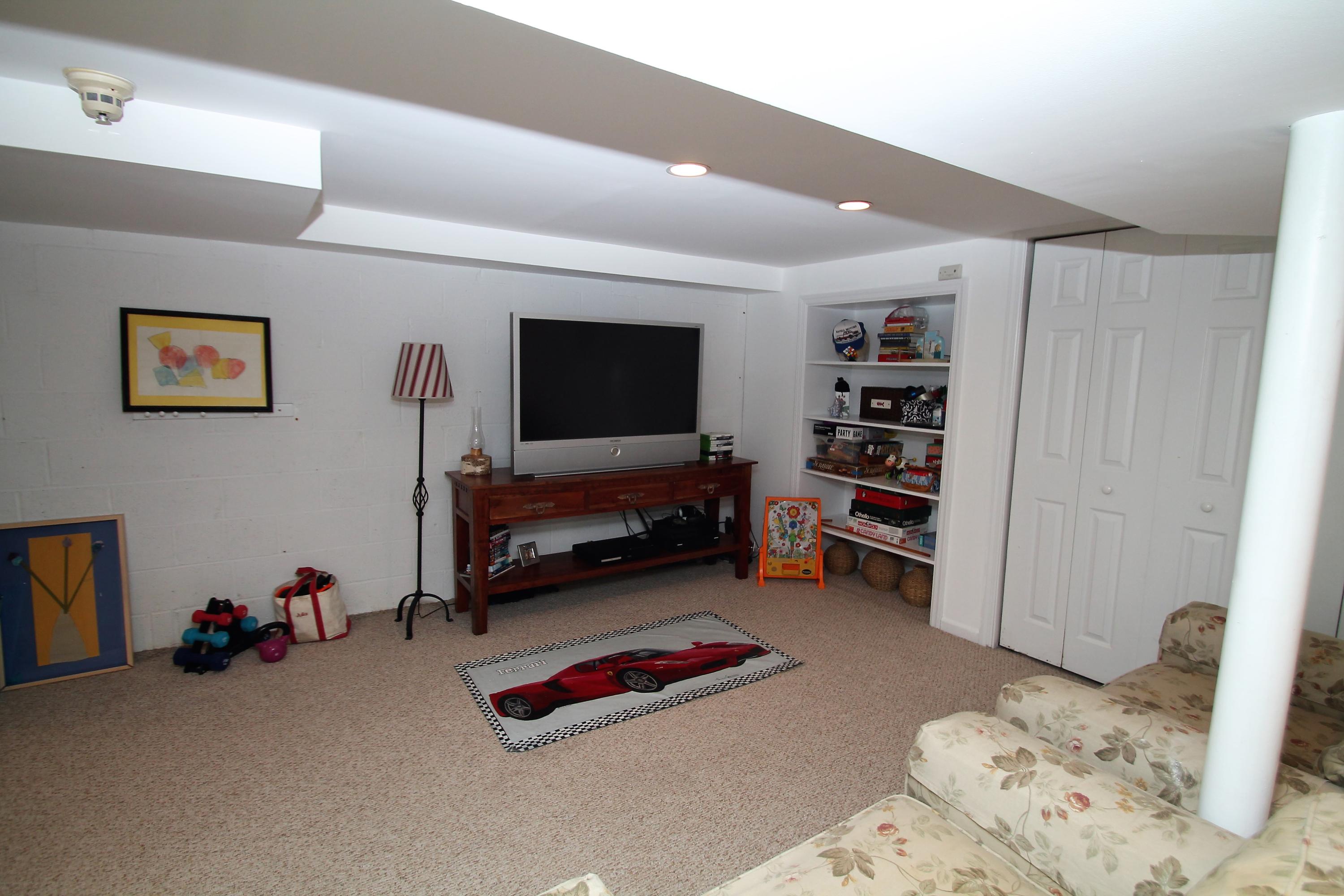 23 Birch Road Darien, CT 06820 - Photo 14 of 17 a bedroom with furniture and a flat screen tv