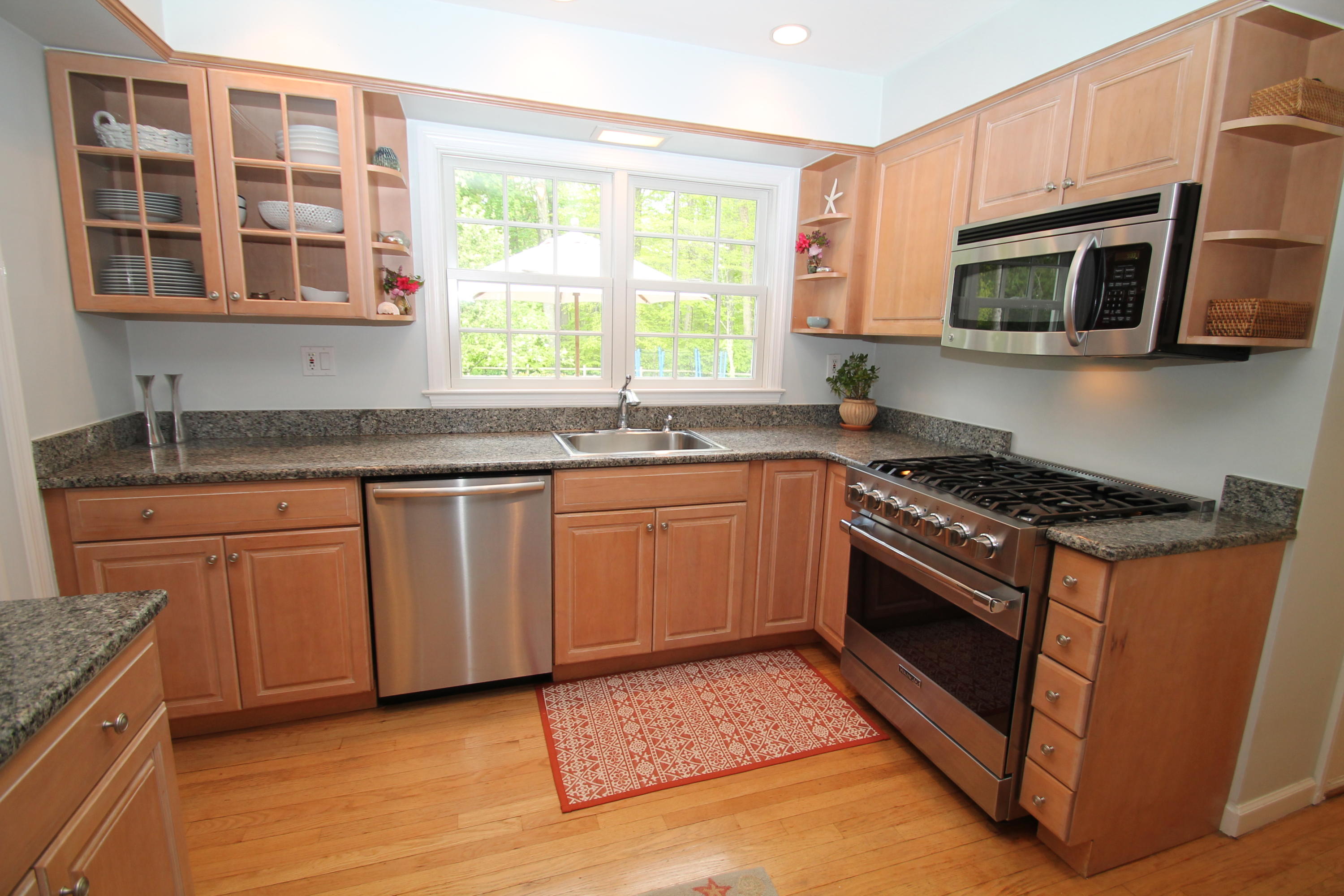 23 Birch Road Darien, CT 06820 - Photo 9 of 17 a kitchen with stainless steel appliances granite countertop a stove a sink and a microwave