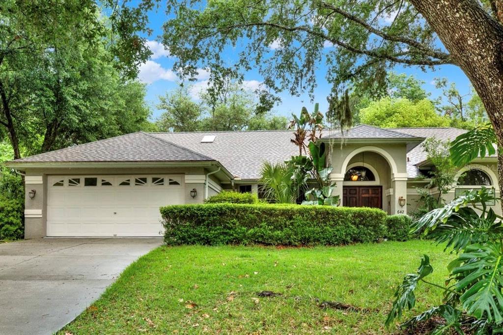 642 Erin Way Brooksville, FL 34601 - Photo 1 of 45 a front view of a house with garden