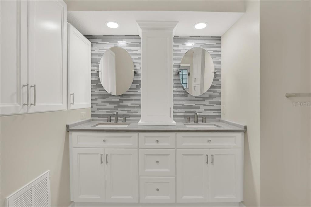 642 Erin Way Brooksville, FL 34601 - Photo 17 of 45 a bathroom with a double vanity sink and mirror