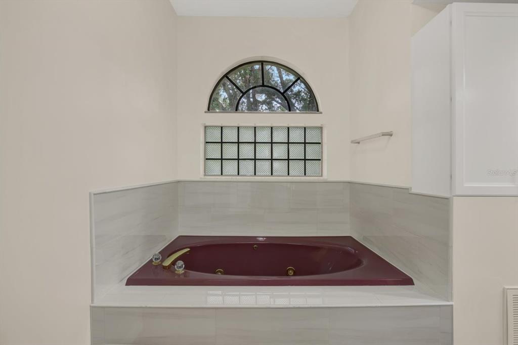 642 Erin Way Brooksville, FL 34601 - Photo 20 of 45 a bathroom with a bathtub and window
