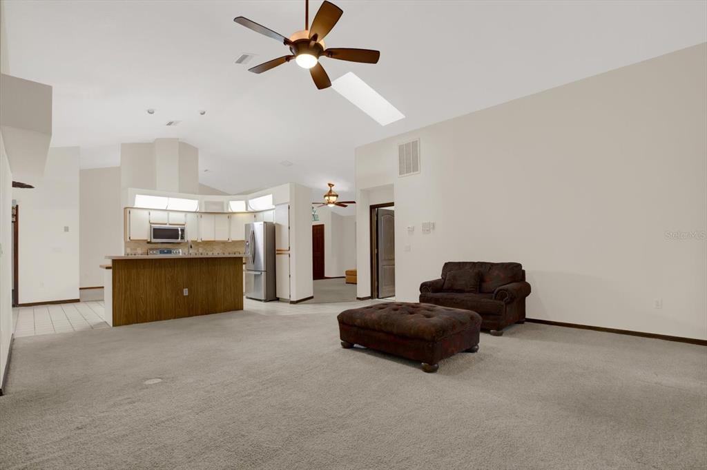 642 Erin Way Brooksville, FL 34601 - Photo 21 of 45 a living room with furniture and a kitchen